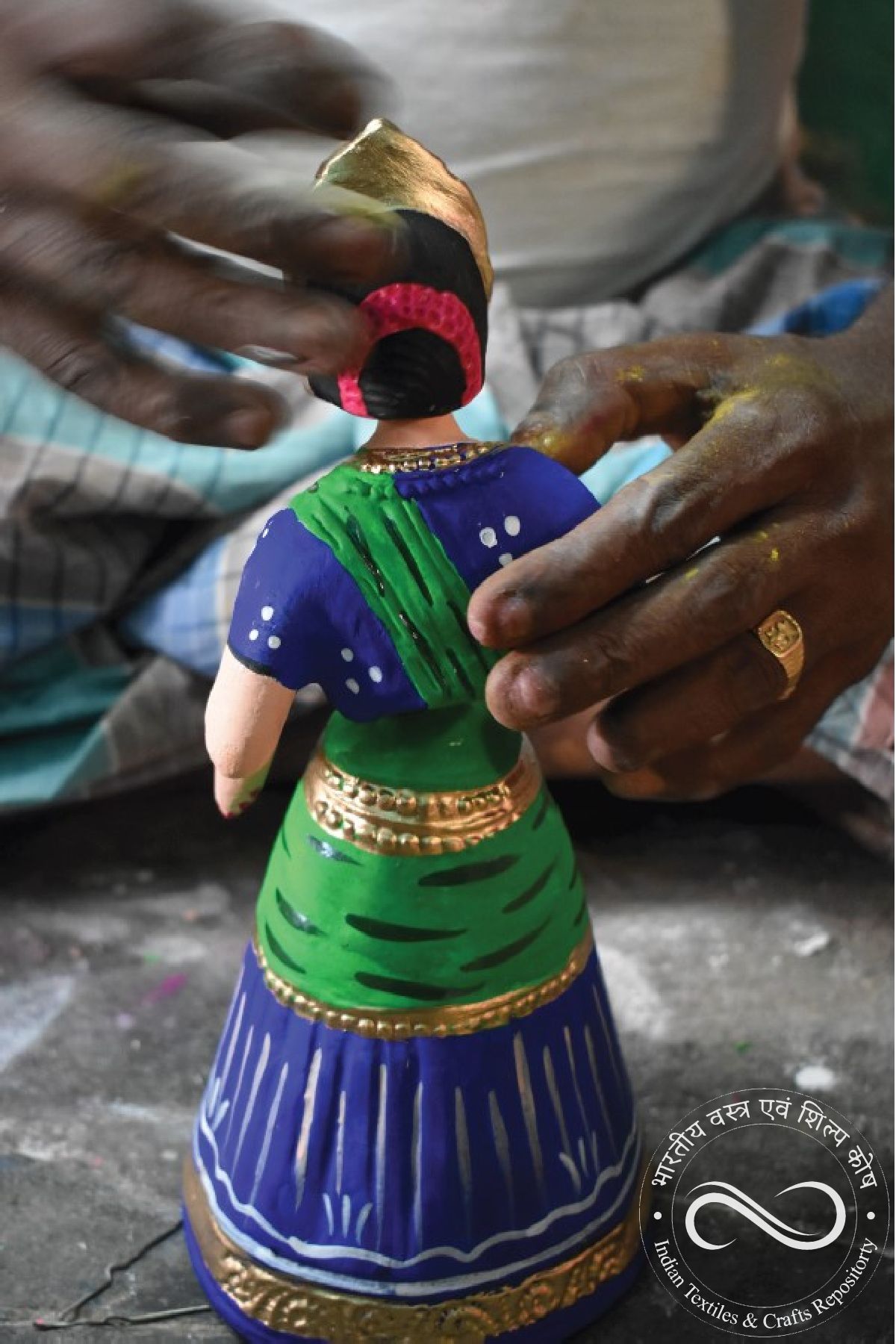 An artisan hand-painting a piece